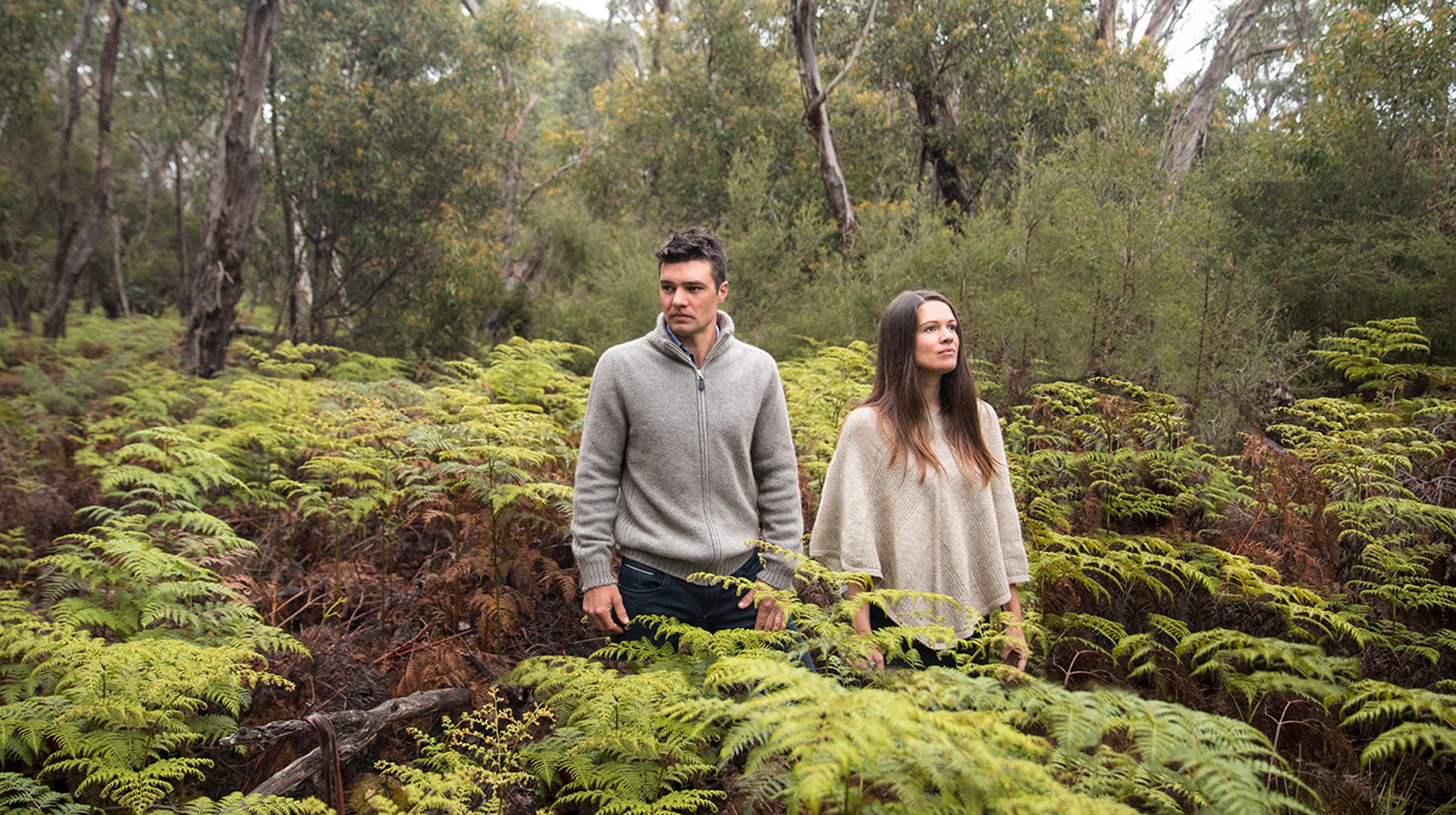 A man and a women wearing Kangaroo Island Wool clothing in Australian fern forrest