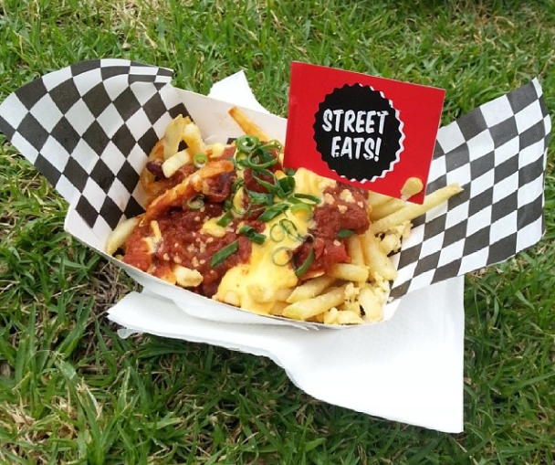 Loaded fries with a small flag proclaiming 'Street eats!'