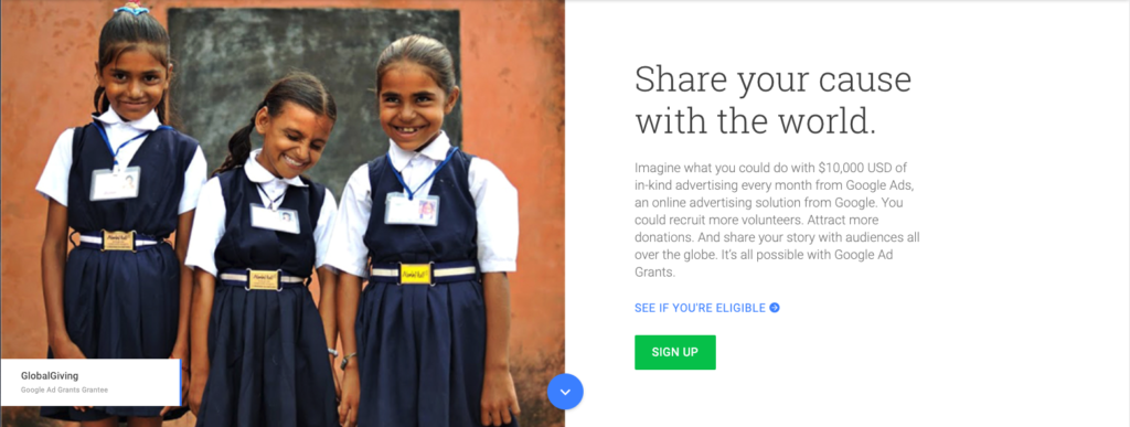 Screenshot of the Google Ads Grant home page. There are three brown skinned girls in school uniforms smiling at the camera. 